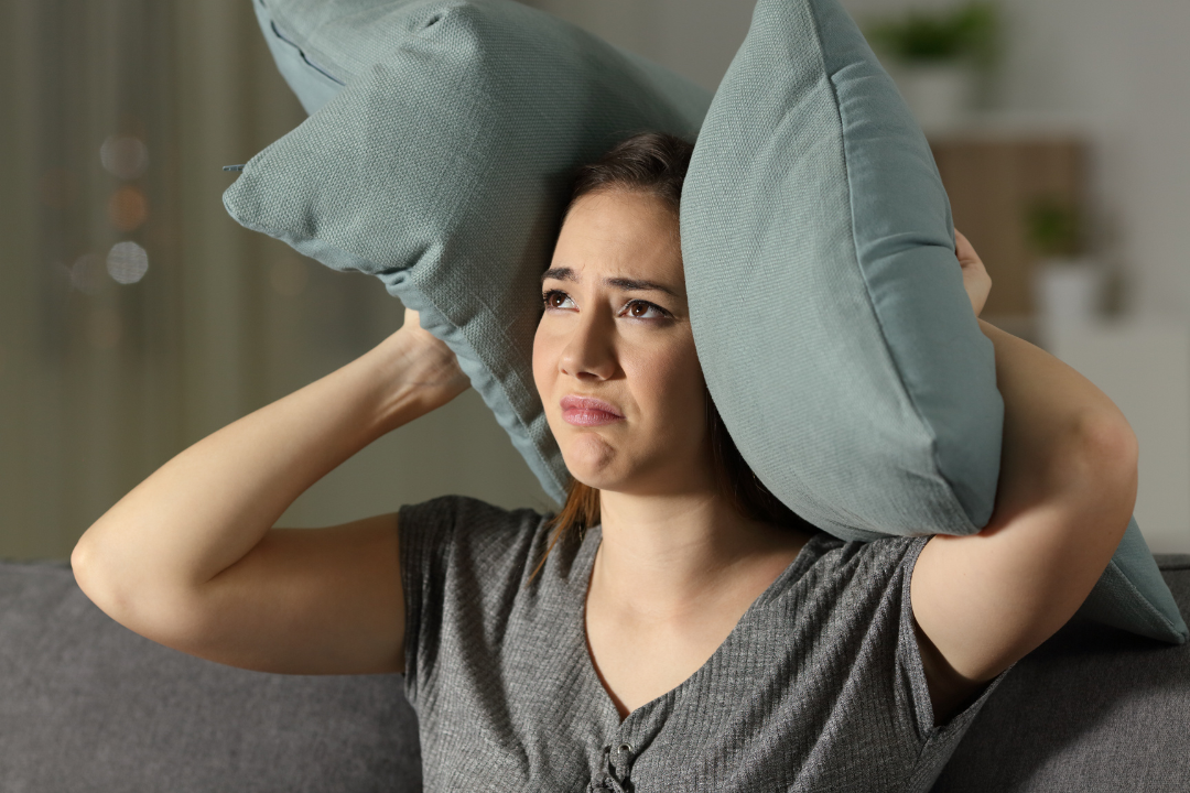 woman covering ears soundproofing
