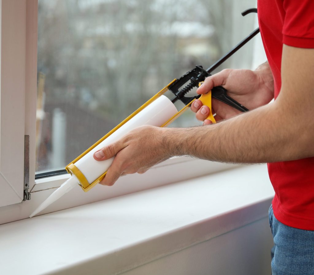 Young worker installing window in flat, closeup